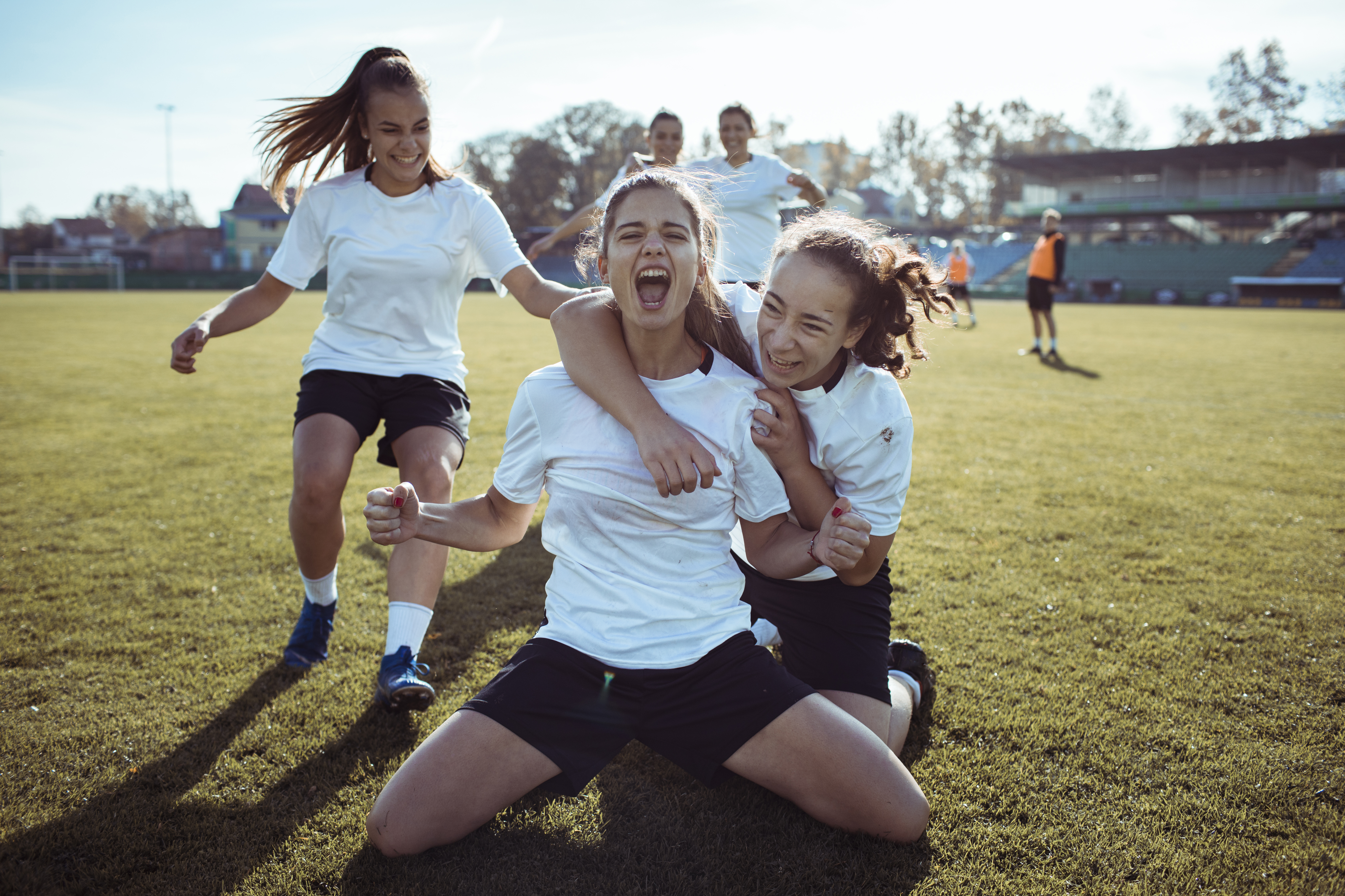 Close up of a female soccer team celebrating a scored goal